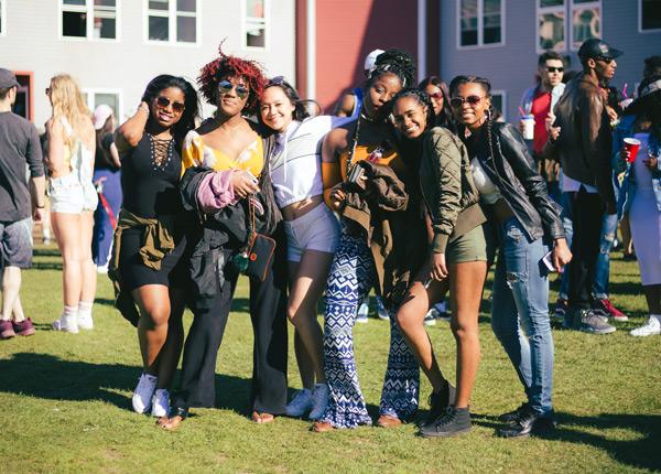 Six students posing in front of dorm housing